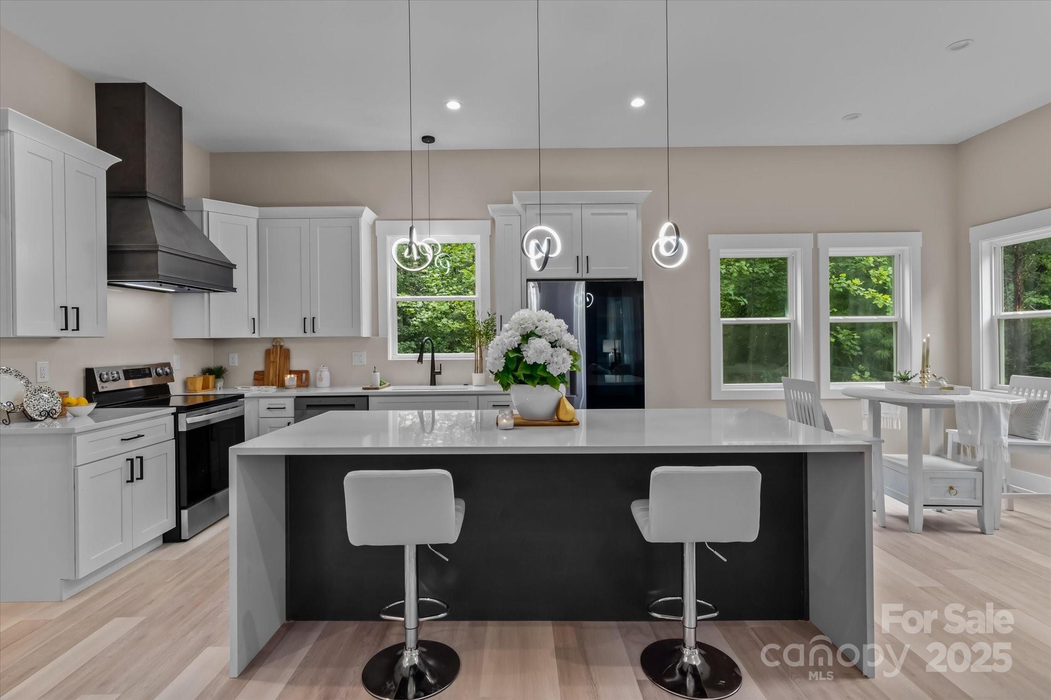 4435 Cornett Drive Iron Station, NC 28080 - Photo 7 of 46 a kitchen with kitchen island granite countertop a sink and a refrigerator