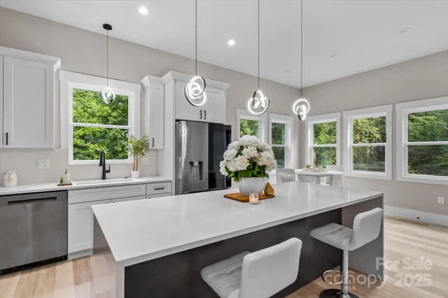 a kitchen with a table chairs and window