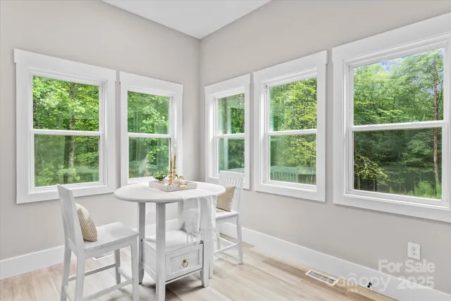 a view of a dining room with furniture and windows