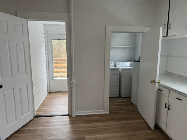 a view of a hallway with wooden floor