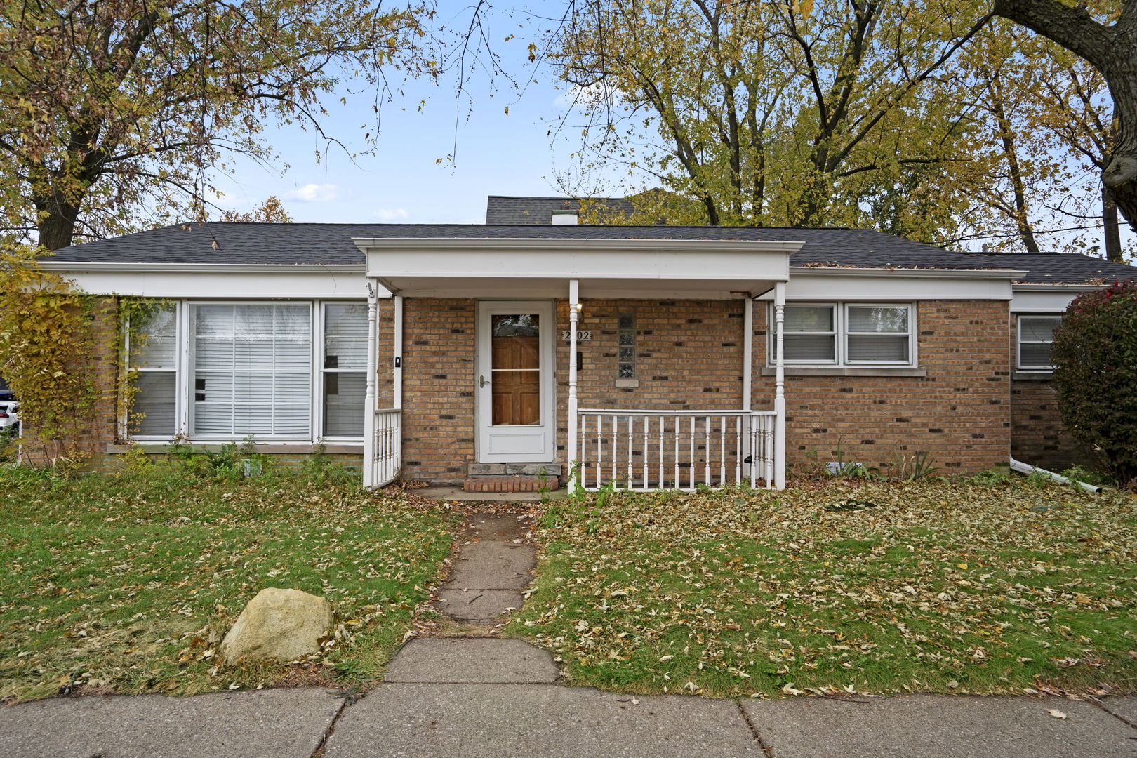 2402 Illinois Road Northbrook, IL 60062 - Photo 1 of 9 front view of a house with a large window and potted plants