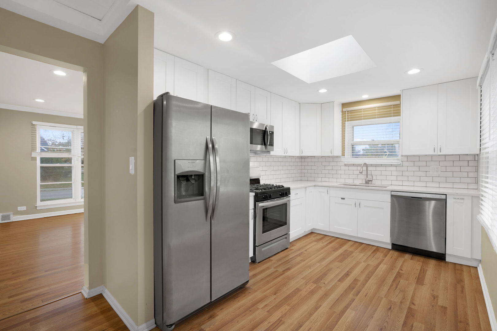 2402 Illinois Road Northbrook, IL 60062 - Photo 3 of 9 a kitchen with granite countertop stainless steel appliances a refrigerator cabinets and wooden floor