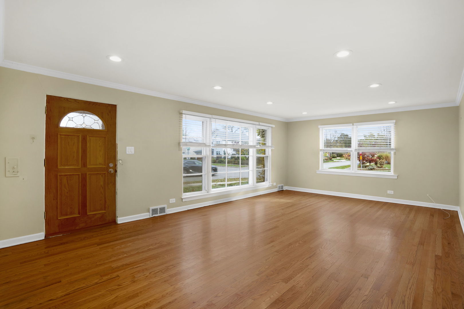 2402 Illinois Road Northbrook, IL 60062 - Photo 4 of 9 a view of an empty room with wooden floor and a window