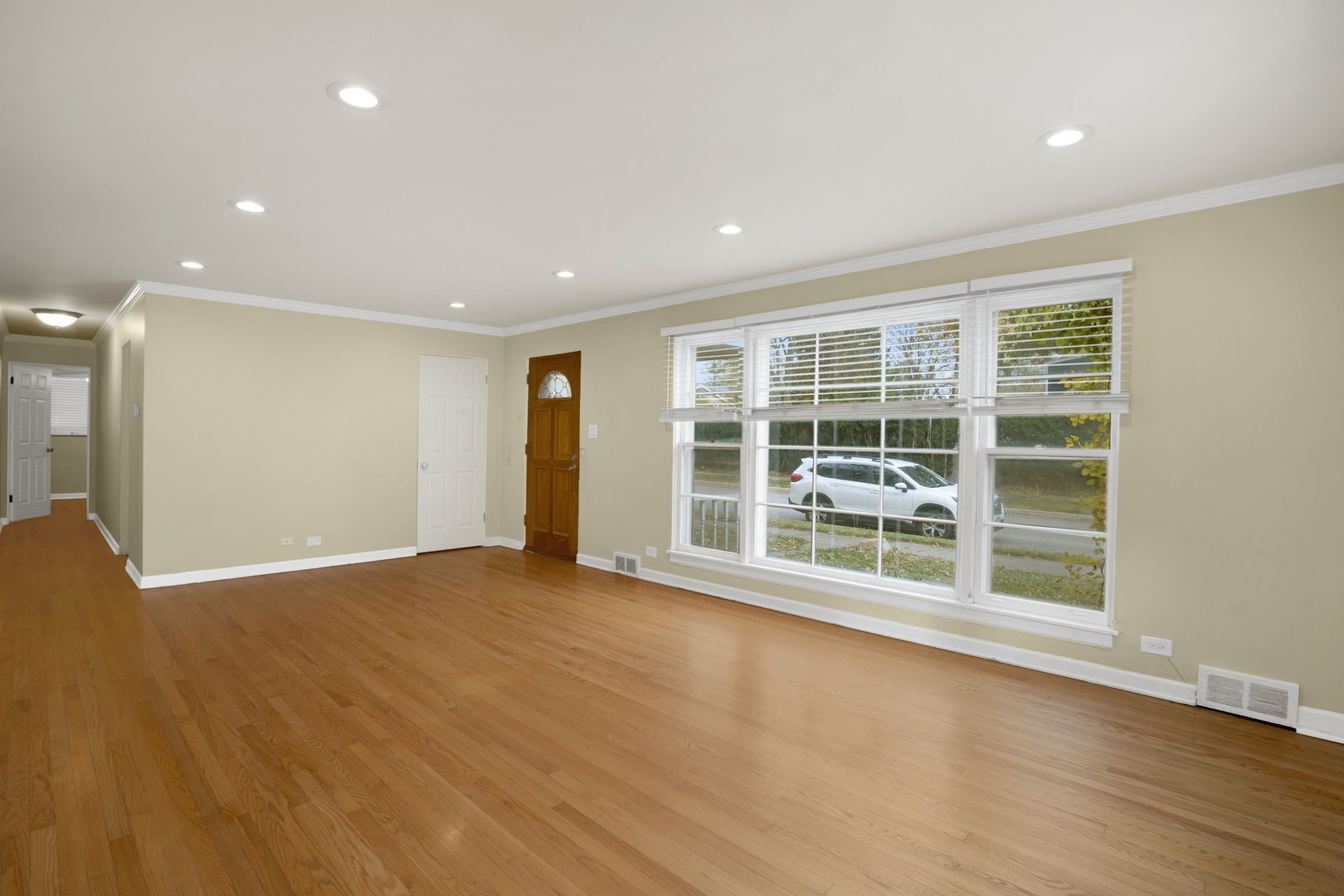 2402 Illinois Road Northbrook, IL 60062 - Photo 5 of 9 a view of an empty room with wooden floor and a window