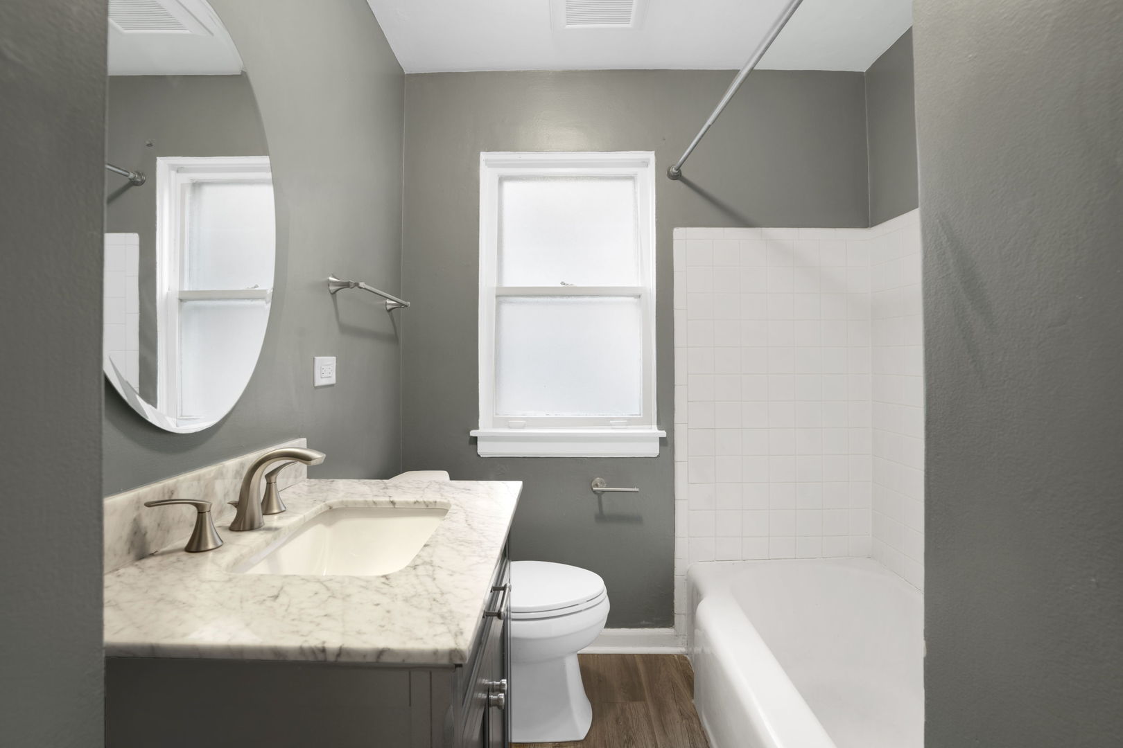 2402 Illinois Road Northbrook, IL 60062 - Photo 6 of 9 a bathroom with a granite countertop sink toilet and a mirror