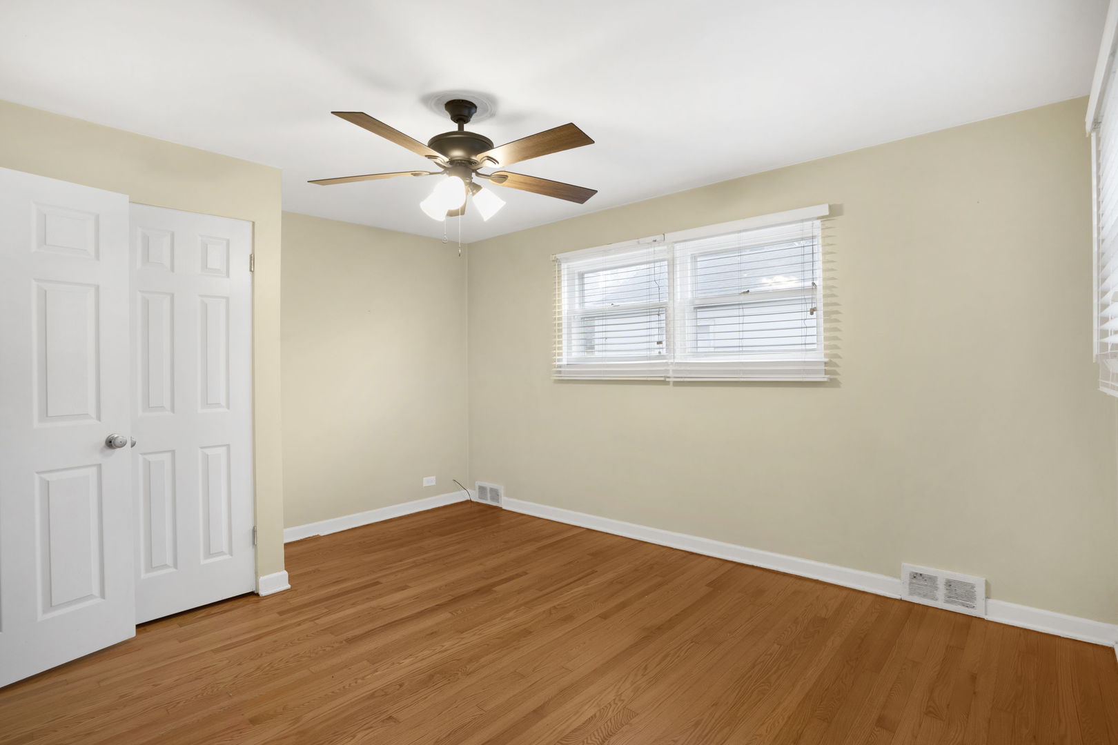 2402 Illinois Road Northbrook, IL 60062 - Photo 8 of 9 a view of an empty room with wooden floor and a window