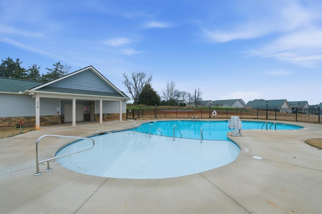 427 Bee Cv Way Pendleton, SC 29670 - Photo 32 of 32 A refreshing community pool with a club house awaits, offering relaxation and fun under the open sky.