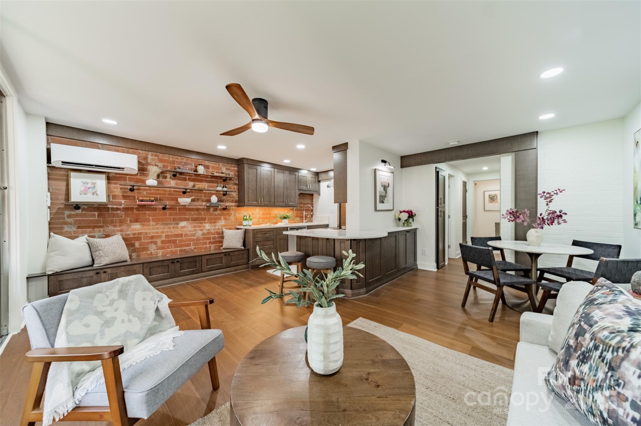 a living room with lots of furniture and view of kitchen