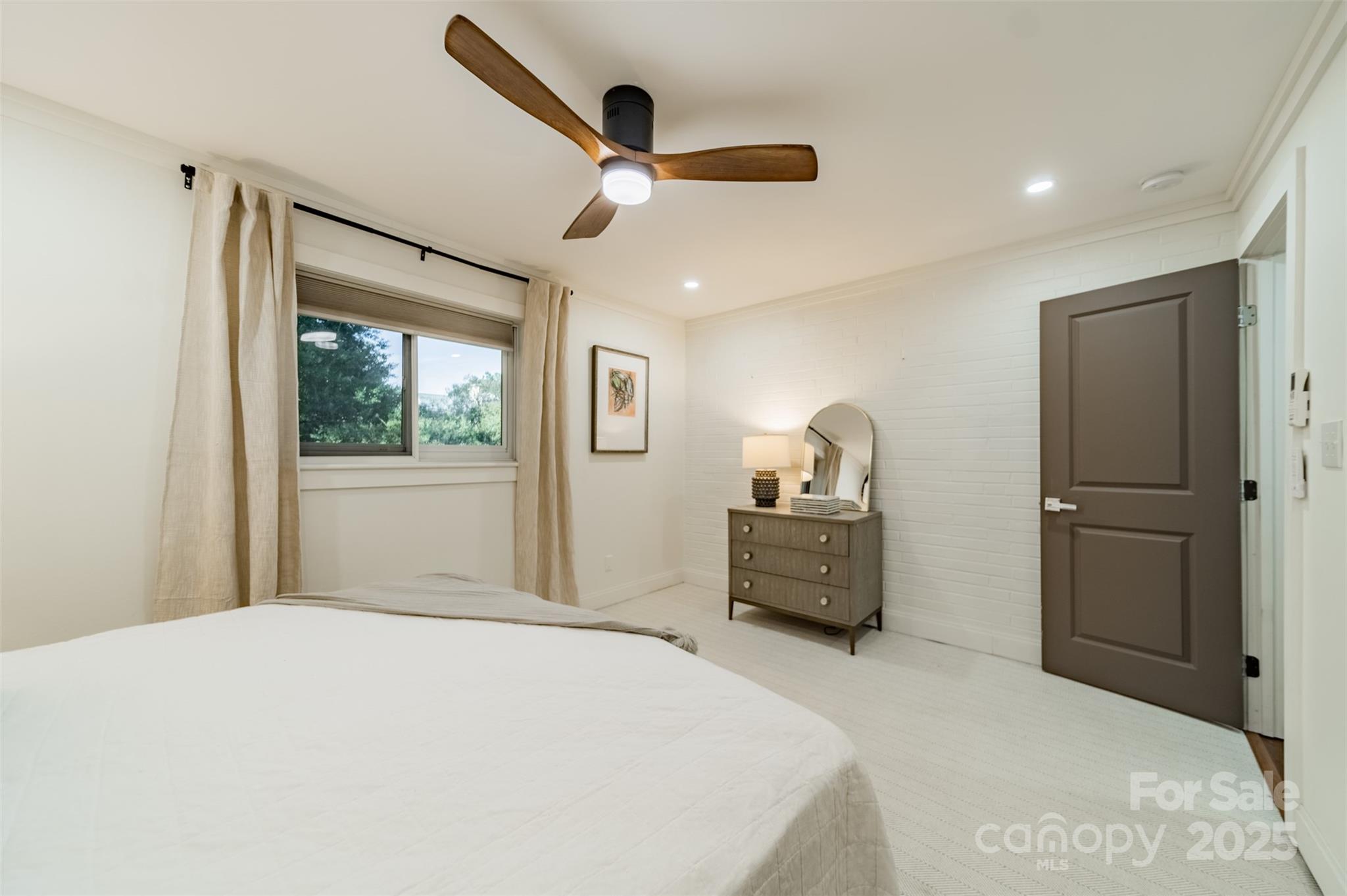 400 Queens Road, Unit D6 Charlotte, NC 28207 - Photo 17 of 26 a bedroom with a bed and a dresser with wooden floor