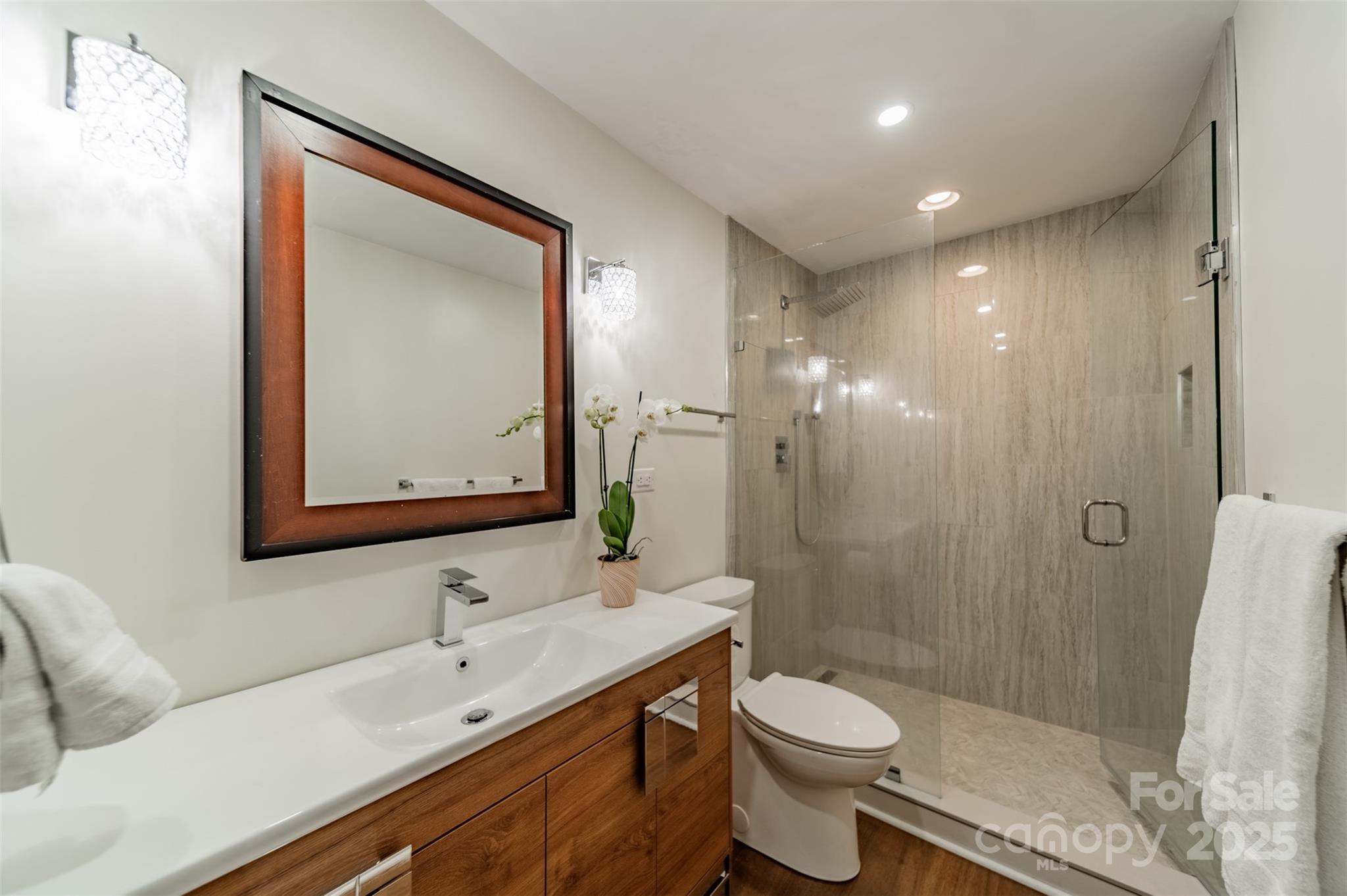 400 Queens Road, Unit D6 Charlotte, NC 28207 - Photo 18 of 26 a bathroom with a sink a toilet and shower