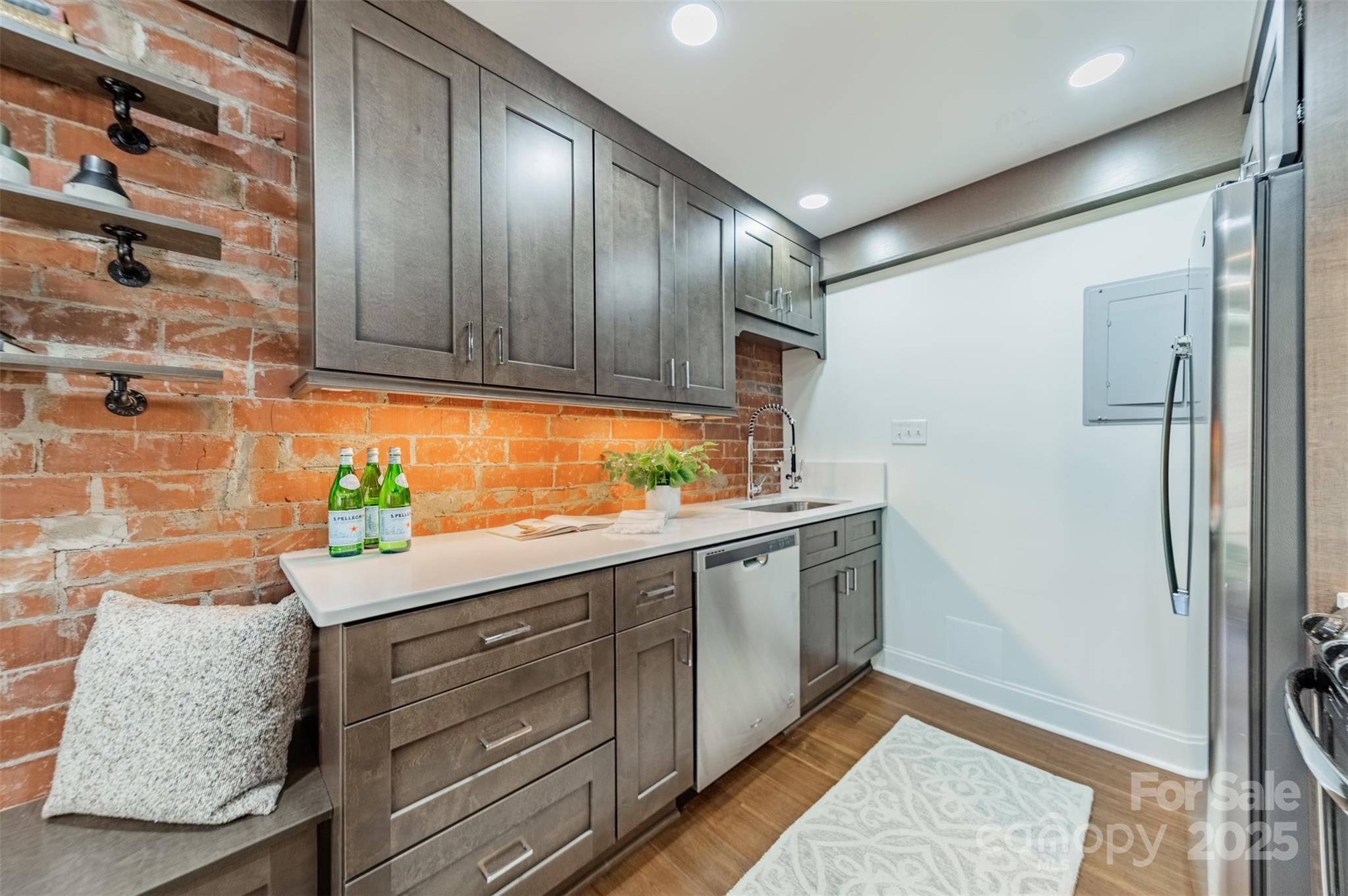 400 Queens Road, Unit D6 Charlotte, NC 28207 - Photo 8 of 26 a kitchen with granite countertop stainless steel appliances and wooden cabinets