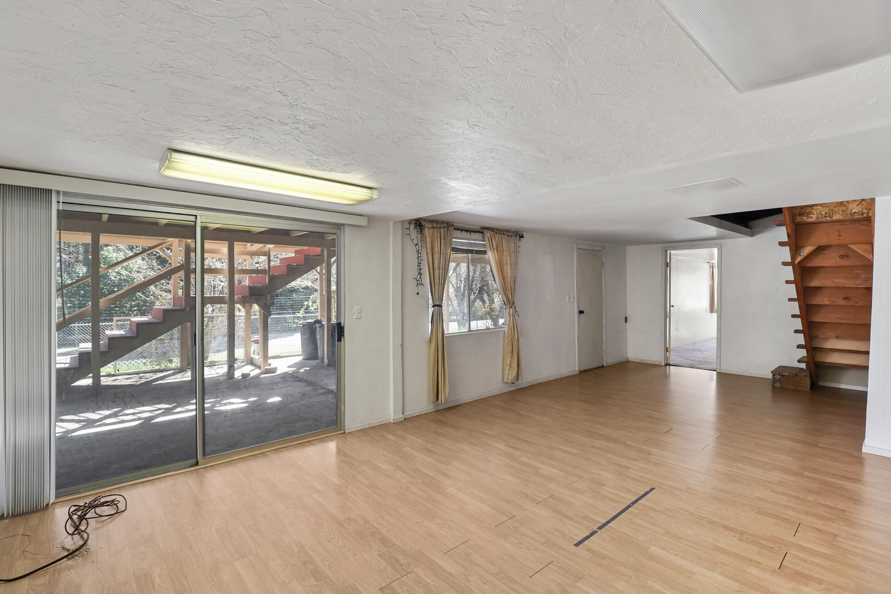 155 Steelhead Circle Lewiston, CA 96052 - Photo 28 of 53 a view of empty room with wooden floor and fan