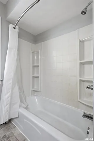 a bathroom with a bathtub and a shower