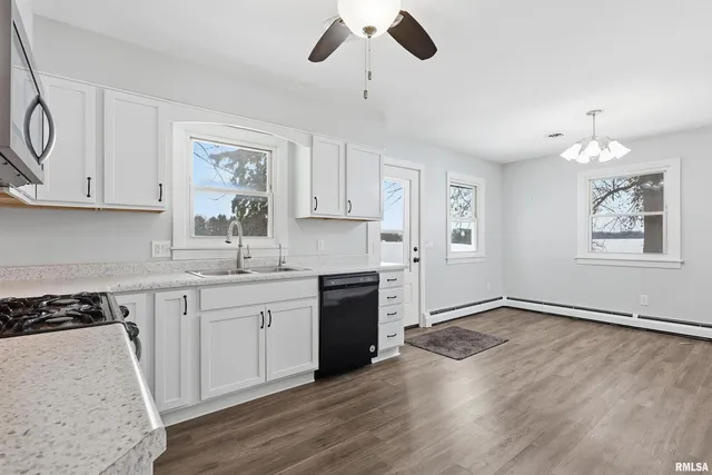 a kitchen with granite countertop white cabinets and white appliances