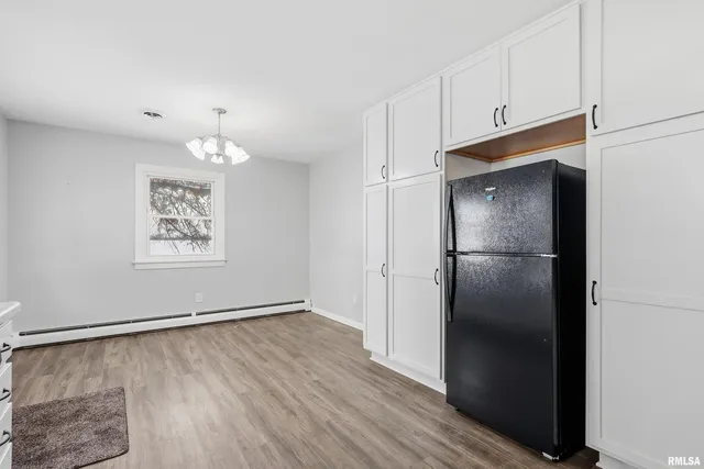a kitchen with a refrigerator and cabinets