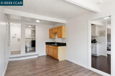 a kitchen with granite countertop a refrigerator and a stove