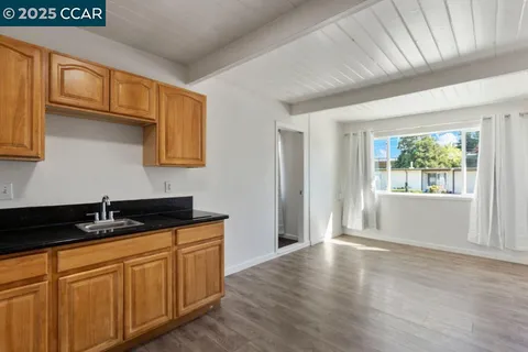 a kitchen with granite countertop wooden cabinets and a granite counter top