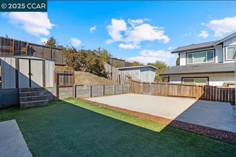 a view of an house with backyard and a slide