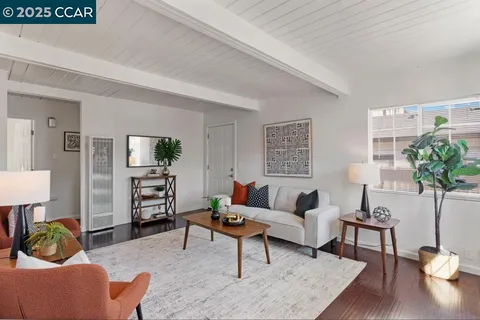 a living room with furniture and a lamp