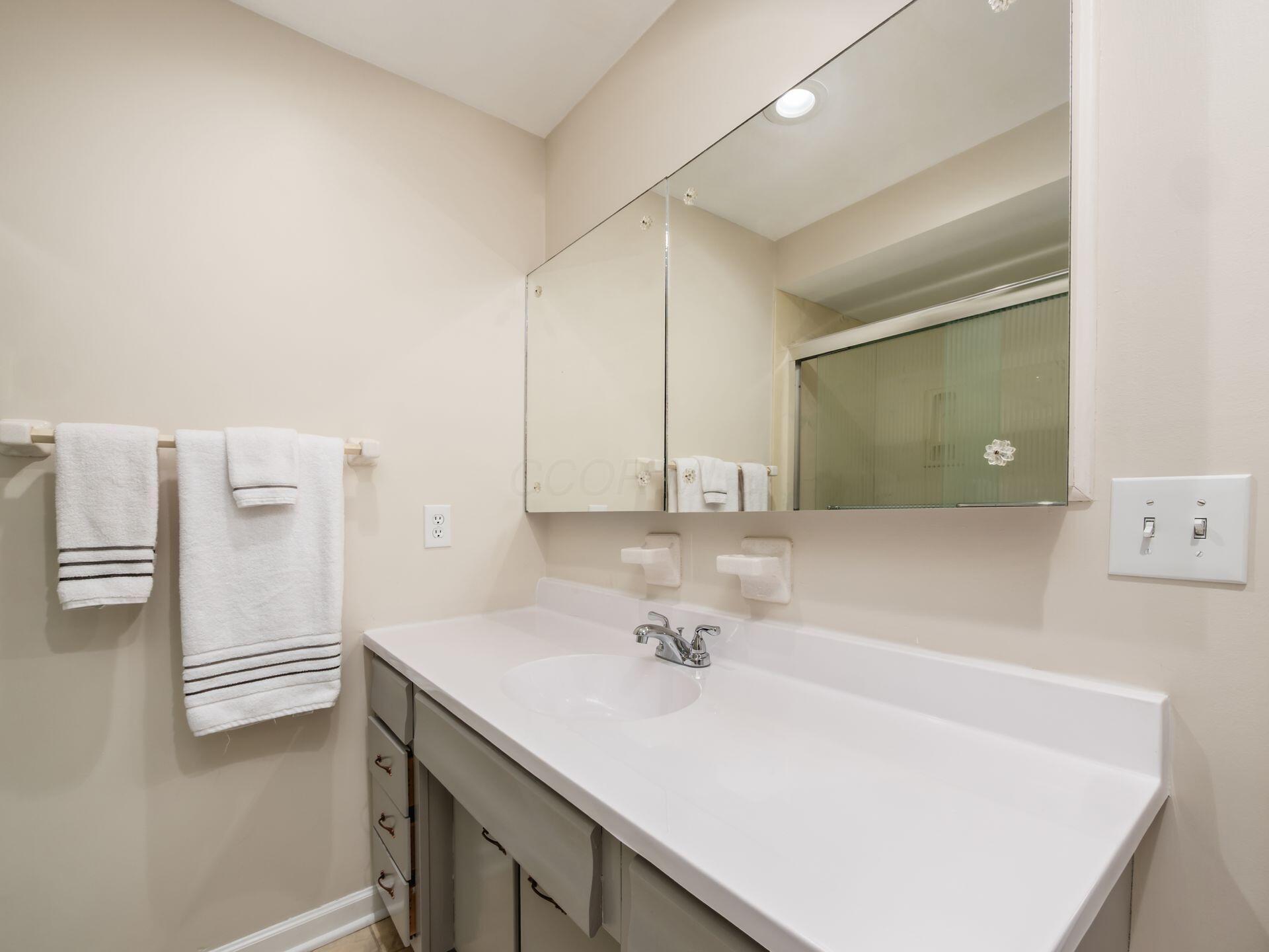 880 Lynbrook Road Columbus, OH 43235 - Photo 44 of 59 New counter-top & faucet. Large built-in medicine cabinet mirror, seperate linen closet