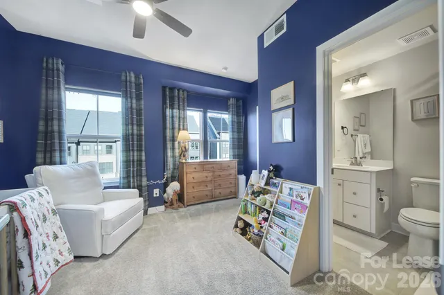 a living room with furniture and wall paintings