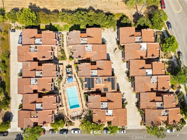 a front view of a building with a garden and plants