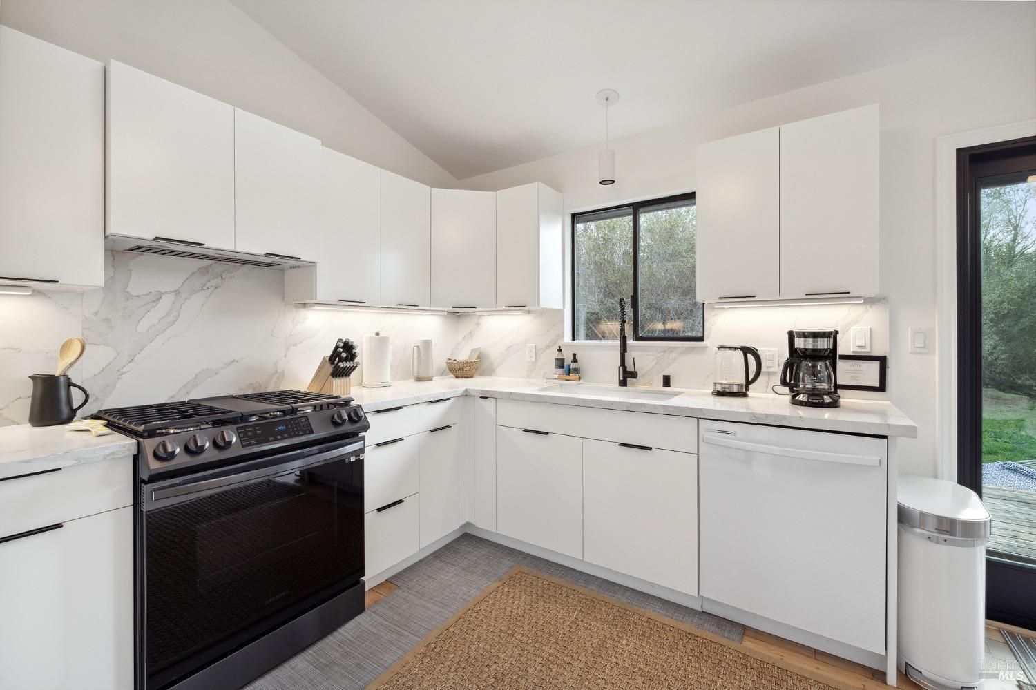 10905 Highway 1 Point Reyes Station, CA 94956 - Photo 13 of 28 a kitchen with white cabinets and appliances