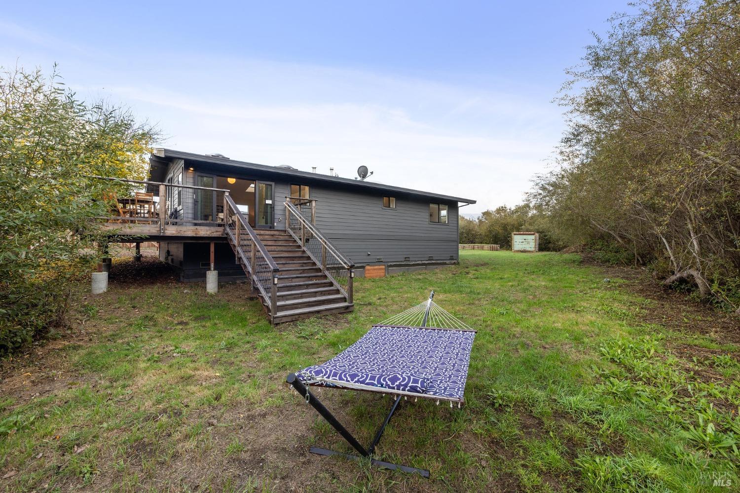 10905 Highway 1 Point Reyes Station, CA 94956 - Photo 20 of 28 a backyard of a house with table and chairs