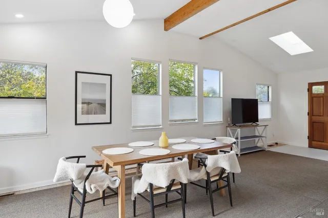 a view of a dining room with furniture and a window