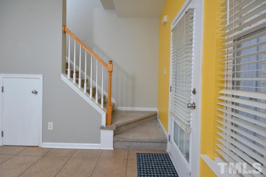 8249 City Loft Court Raleigh, NC 27613 - Photo 15 of 28 a view of a hallway with wooden floor and staircase