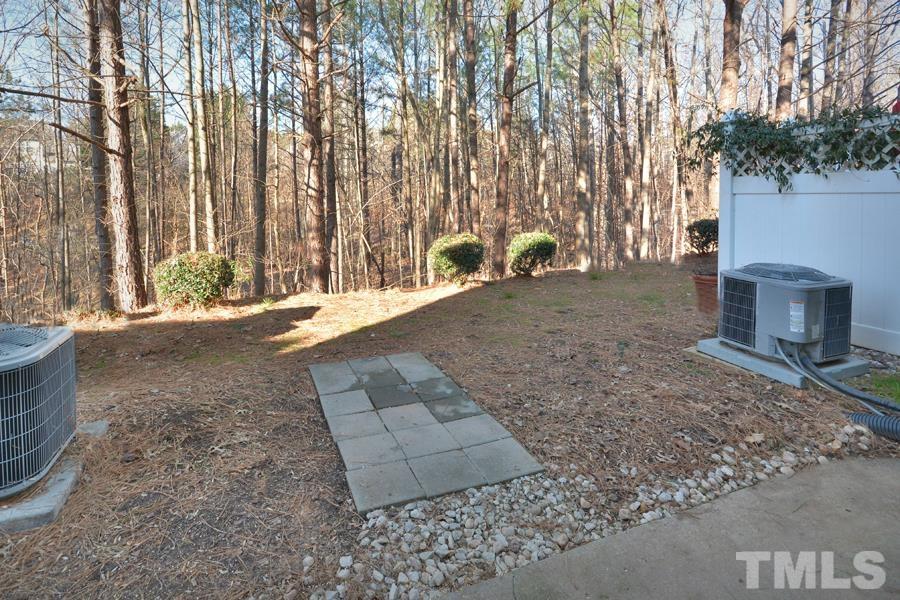8249 City Loft Court Raleigh, NC 27613 - Photo 17 of 28 a backyard of a house with barbeque oven a table and chairs