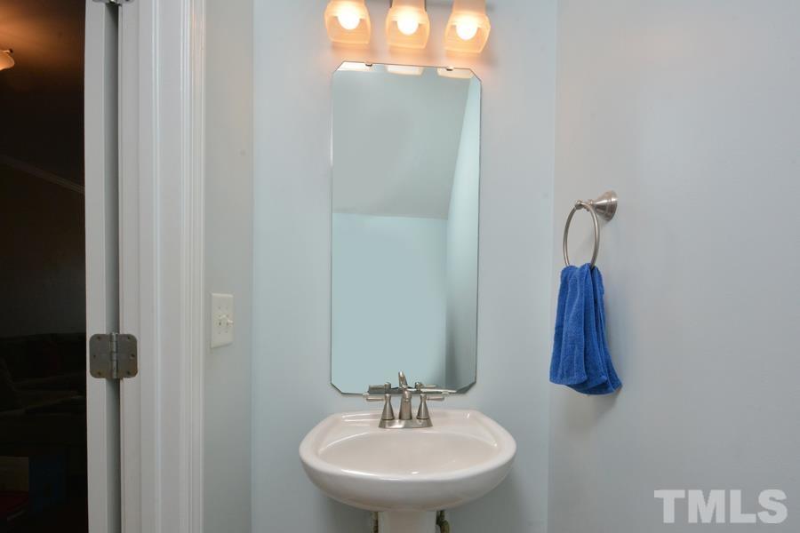 8249 City Loft Court Raleigh, NC 27613 - Photo 19 of 28 a bathroom with a sink and a mirror