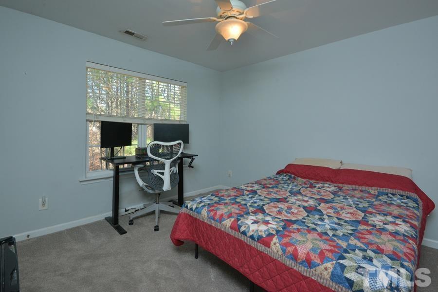 8249 City Loft Court Raleigh, NC 27613 - Photo 24 of 28 a bedroom with a bed and a window