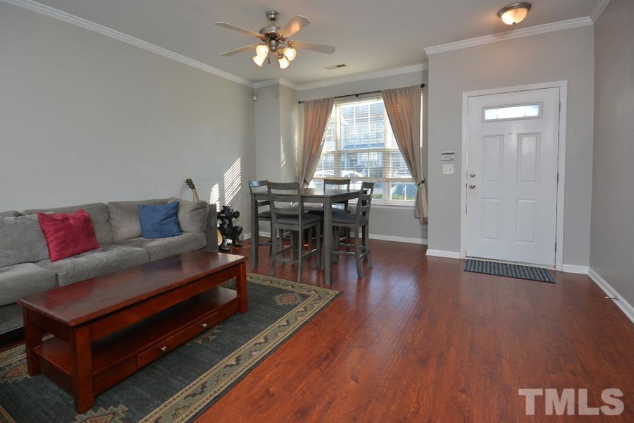 8249 City Loft Court Raleigh, NC 27613 - Photo 3 of 28 a living room with furniture a wooden floor and a window