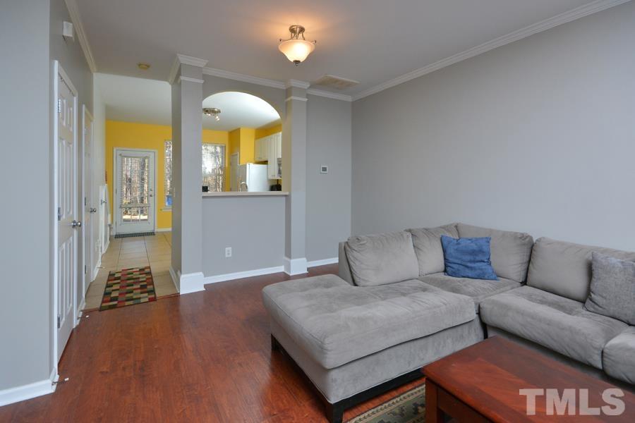 8249 City Loft Court Raleigh, NC 27613 - Photo 4 of 28 a living room with furniture and a chandelier