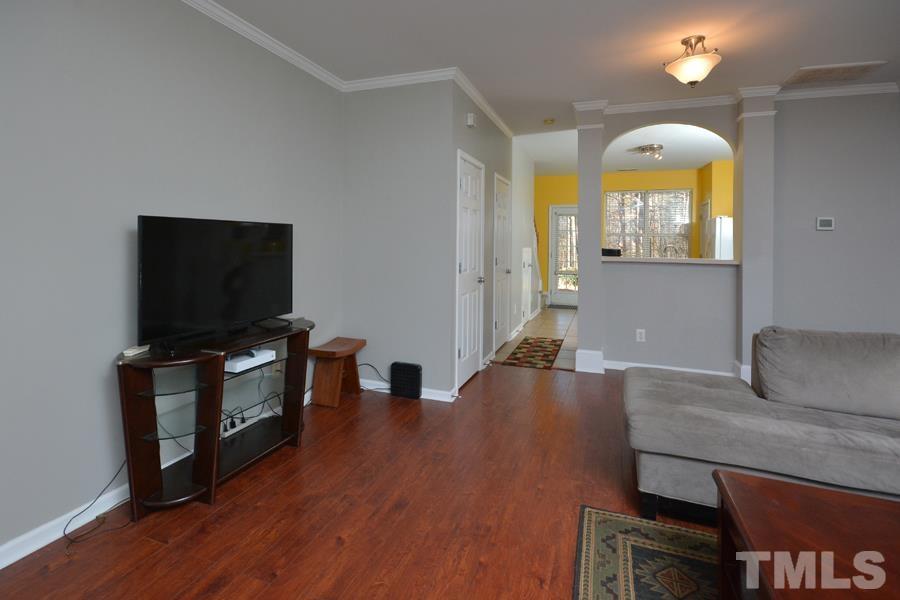 8249 City Loft Court Raleigh, NC 27613 - Photo 5 of 28 a living room with furniture and a flat screen tv
