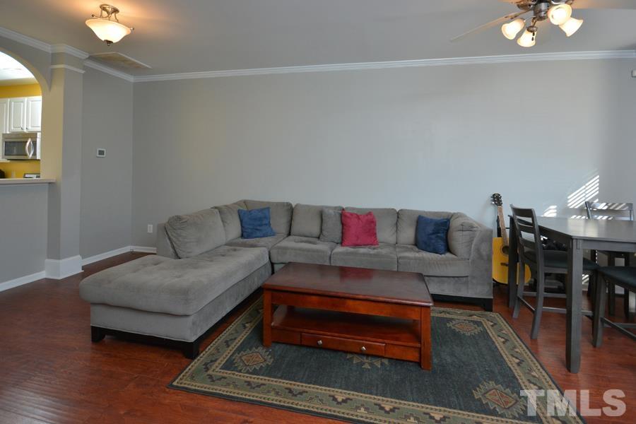8249 City Loft Court Raleigh, NC 27613 - Photo 6 of 28 a living room with furniture and wooden floor