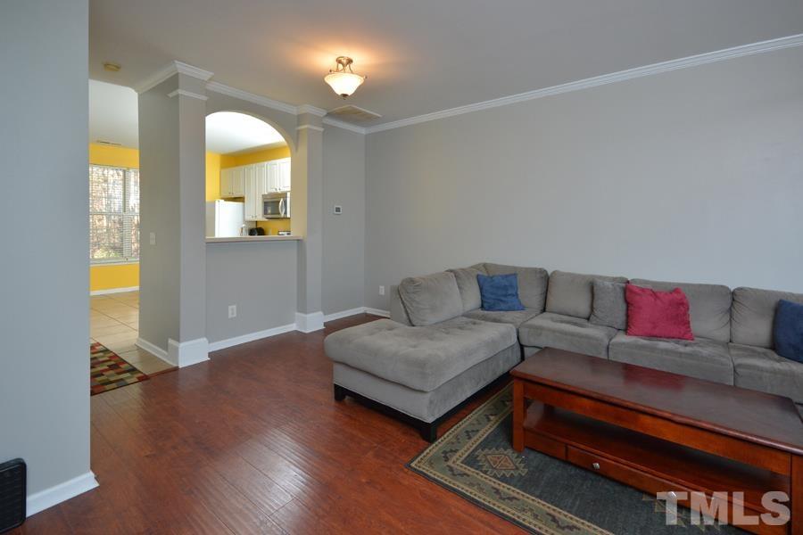 8249 City Loft Court Raleigh, NC 27613 - Photo 7 of 28 a living room with furniture and a wooden floor