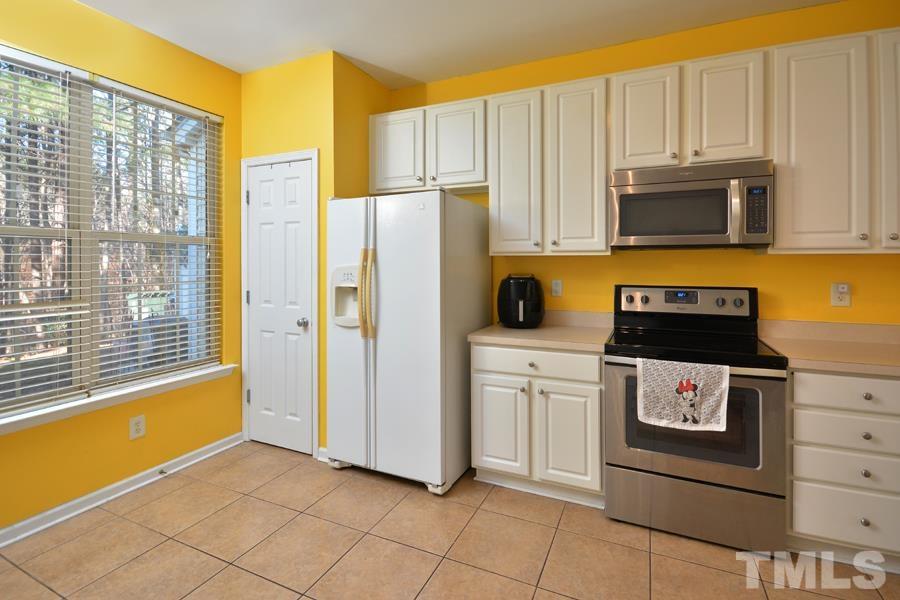 8249 City Loft Court Raleigh, NC 27613 - Photo 10 of 28 a kitchen with stainless steel appliances granite countertop a refrigerator and a stove