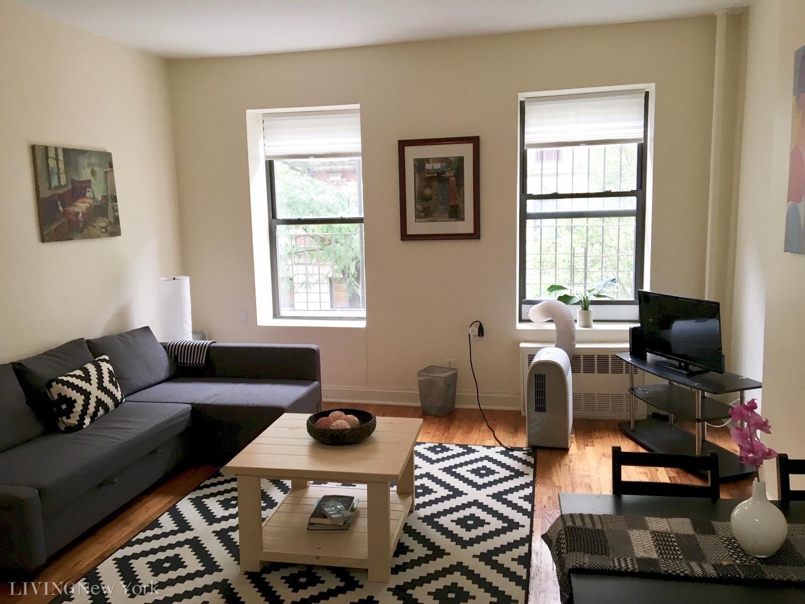 21 East 108th Street, Unit 4A Manhattan, NY 10029 - Photo 1 of 6 a living room with furniture and a window