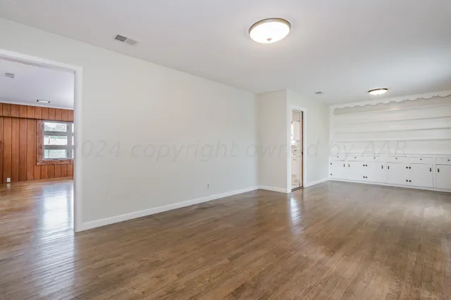 a view of an empty room and wooden floor