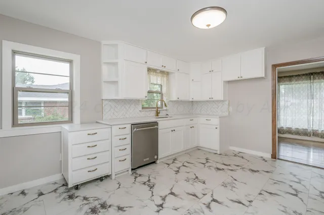 a kitchen with a sink stove and cabinets