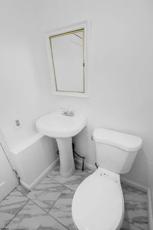a white toilet sitting next to a bathroom sink