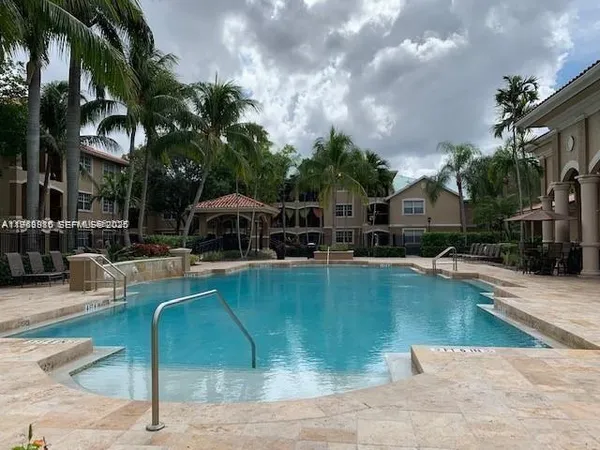 a swimming pool with outdoor seating and yard