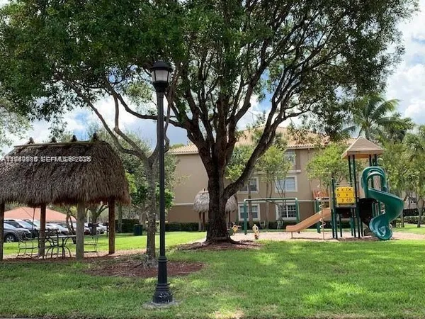a view of a house with backyard porch and sitting area