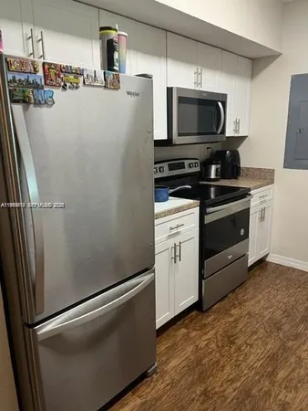 a kitchen with stainless steel appliances a refrigerator a stove top oven a sink and dishwasher