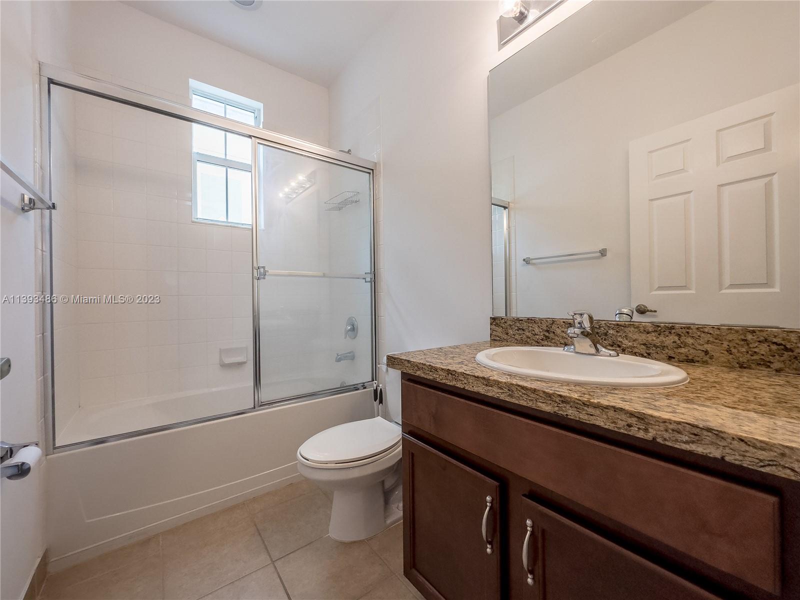 865 Southwest 147th Avenue, Unit 1908 Pembroke Pines, FL 33027 - Photo 12 of 30 a bathroom with a granite countertop sink toilet and shower