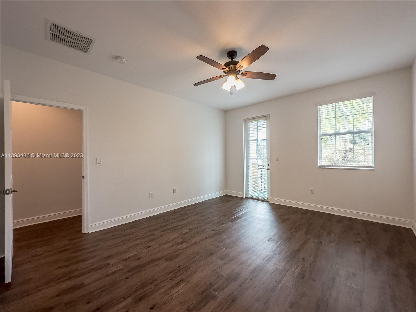 865 Southwest 147th Avenue, Unit 1908 Pembroke Pines, FL 33027 - Photo 14 of 30 a view of an empty room with wooden floor and a window