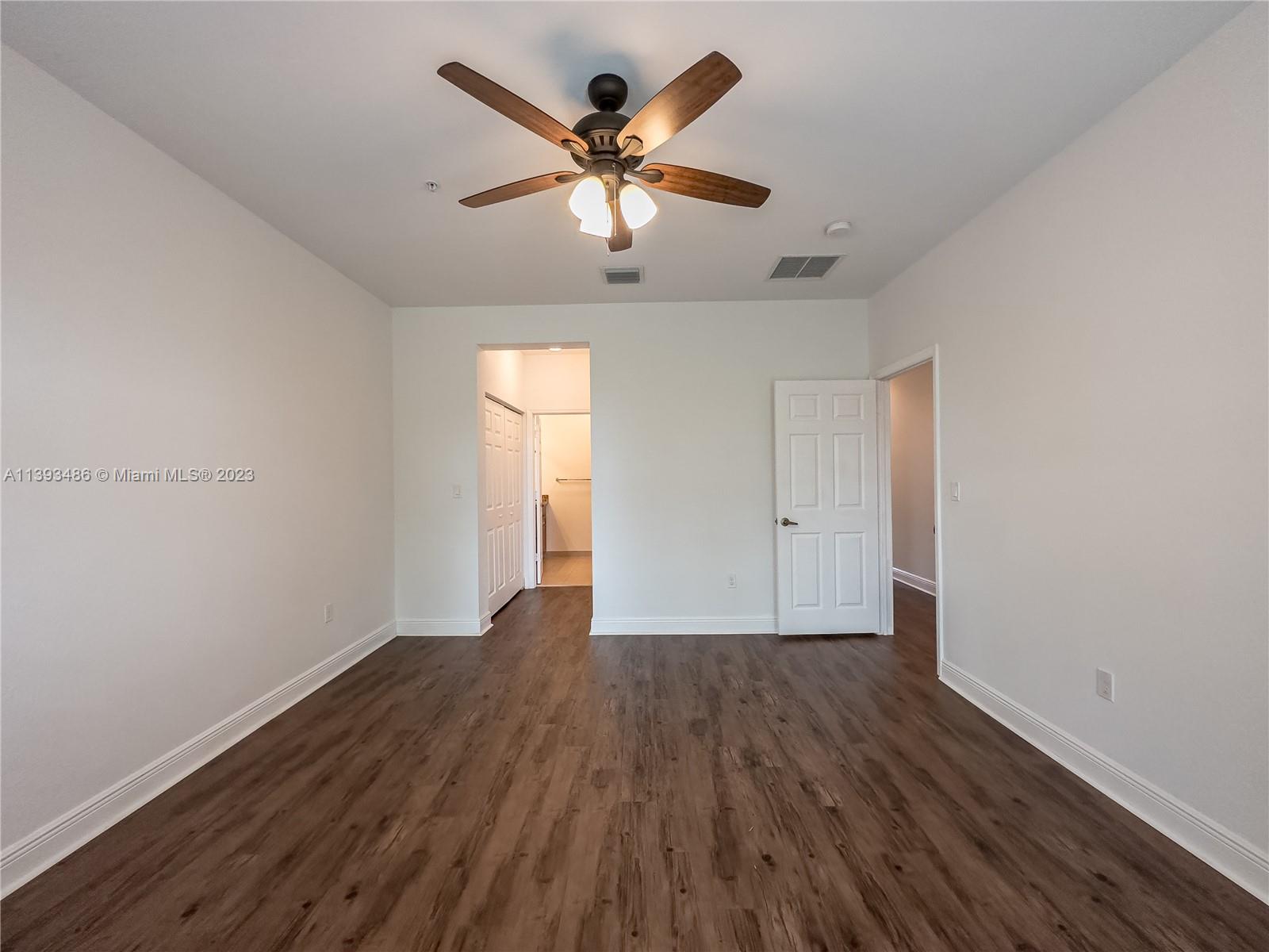 865 Southwest 147th Avenue, Unit 1908 Pembroke Pines, FL 33027 - Photo 16 of 30 wooden floor in an empty room with a window
