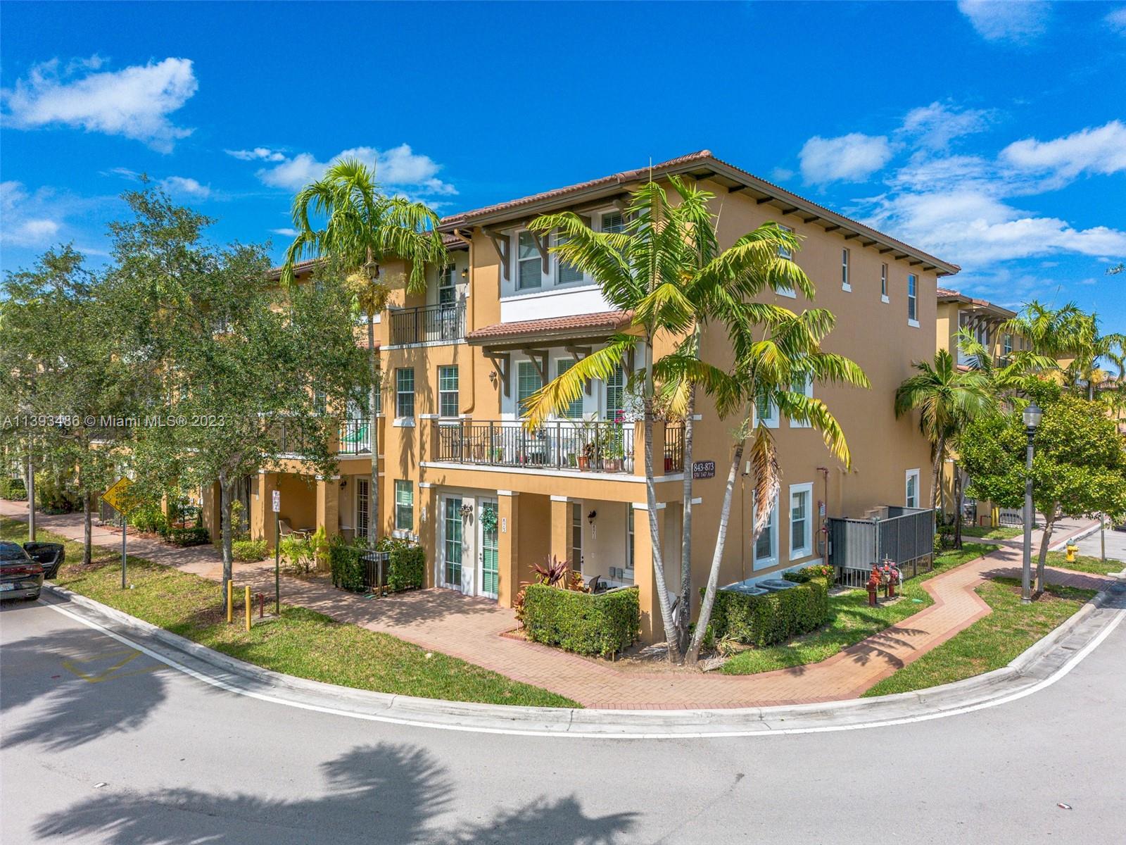 865 Southwest 147th Avenue, Unit 1908 Pembroke Pines, FL 33027 - Photo 2 of 30 a front view of a house with a yard